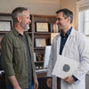 Veteran consulting with a physician about an independent medical evaluation, nexus letter, and VA disability benefits in a professional medical office.